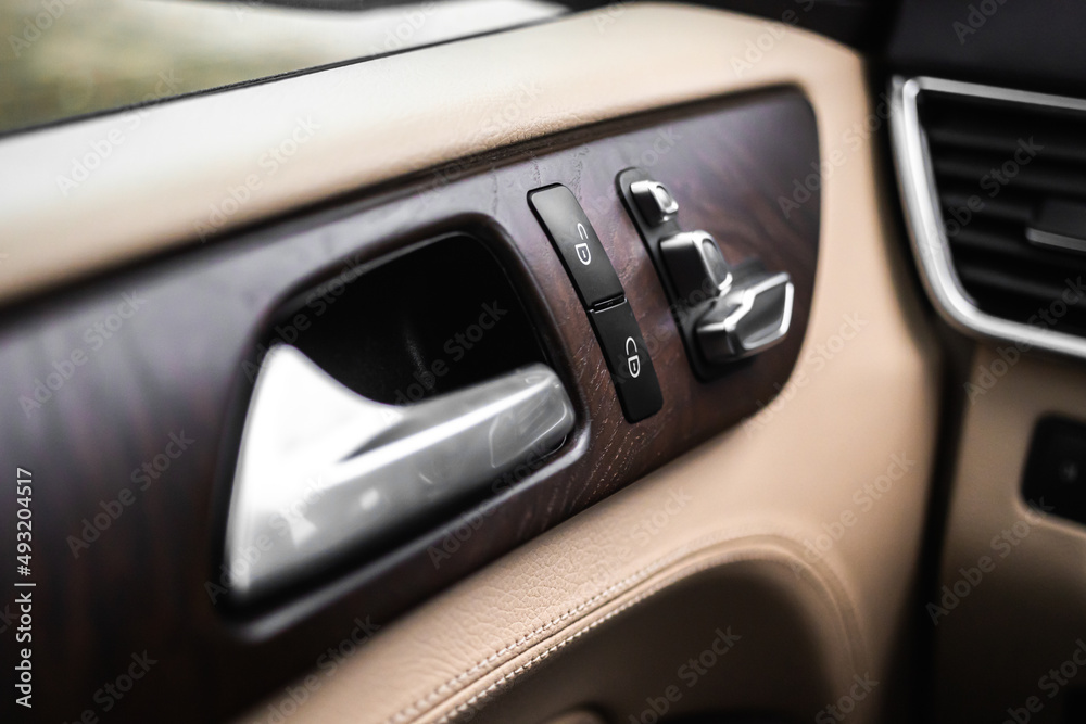Car door handle and lock switch inside luxury and modern vehicle with leather interior, design background photo