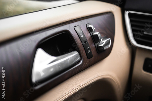 Car door handle and lock switch inside luxury and modern vehicle with leather interior, design background photo