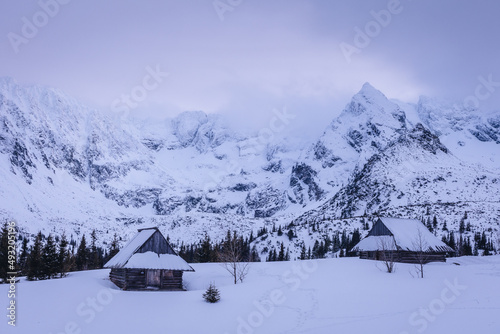 Mountain chalet in the Tatras during the blue hour. Winter mountain landscape with a view of the mountain ridges. © PawelUchorczak