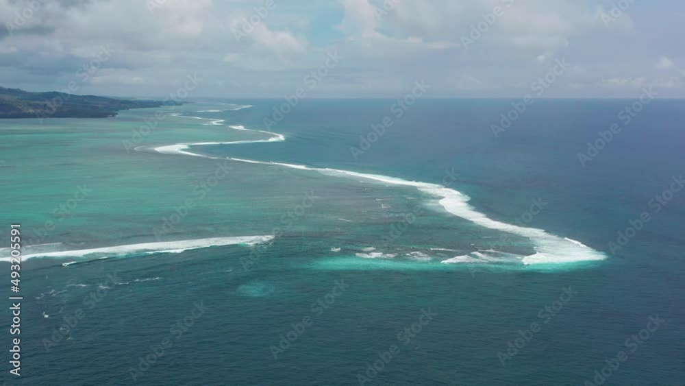 Beautiful beach with turquoise water in Mauritius. Wild paradise beach white sand high coconut palm trees natural exotic landscape. Ocean waves blue transparent clear water.