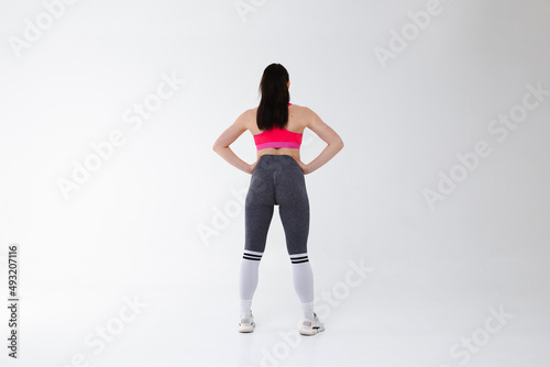 Fitness girl posing in the studio on the white background