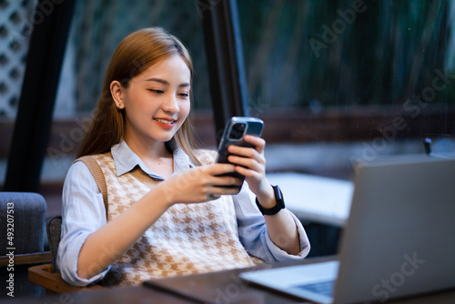 Young Asian business woman working at coffee shop