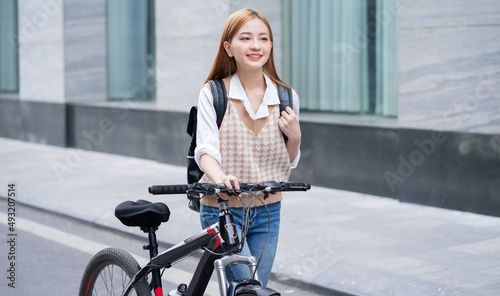 Young Asian woman using bicycle as a means of transportation