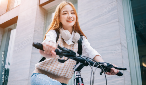 Young Asian woman using bicycle as a means of transportation