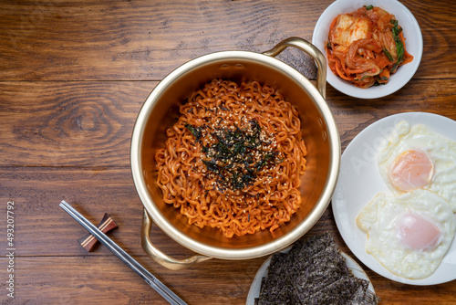 Korean traditional Ramyeon noodle in a traditional korean noodle pot, Spicy Korean Ramyeon instant noodle a traditional dish.