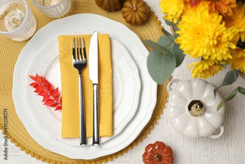 Autumn table setting with floral decor and pumpkins  flat lay