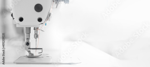 Fotografia, Obraz Banner industry tailor sewing machine on table workshop of white background