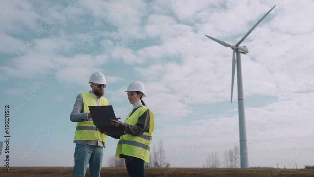 custom made wallpaper toronto digitalEcological engineers discussing information at the windmill field. Environmental engineers work at the sustainable power station, wearing safety vests, shot from far. High quality 4k footage