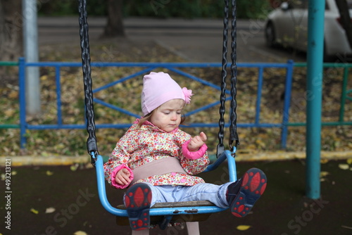 Portrait of little girl playing outdoors. Autumn