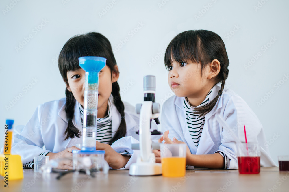 Two girls doing science experiments in a lab. Two girls doing science experiments in a lab.