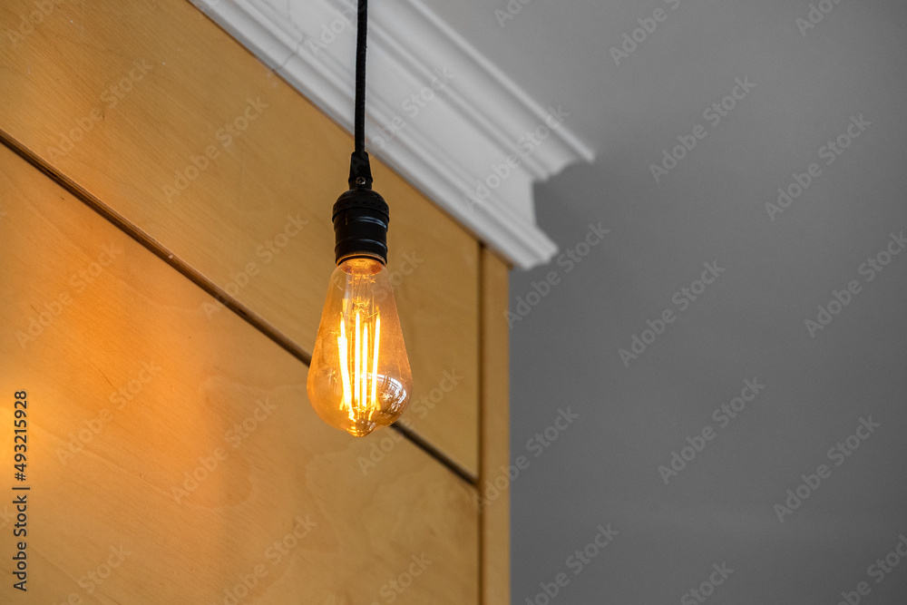 Incandescent lamp on the background of a yellow wall Incandescent lamp on the background of a yellow wall