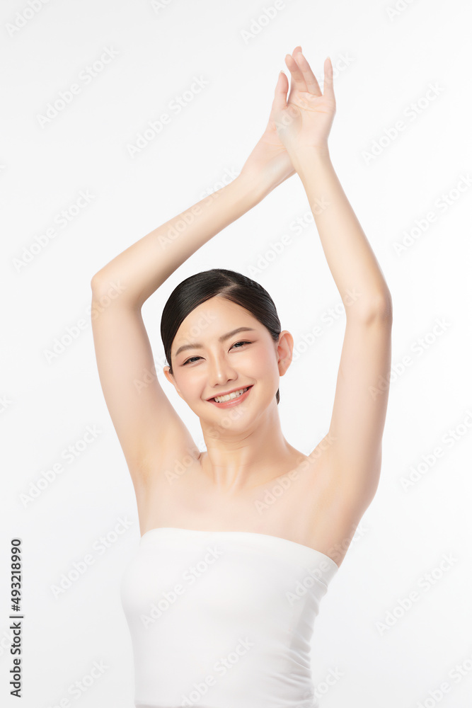 Beautiful Young Asian woman lifting hands up to show off clean and hygienic armpits or underarms on white background, Smooth armpit cleanliness and protection concept