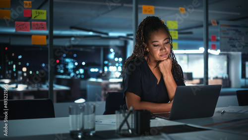 Portrait of African American Businesswoman Working on Laptop Computer in Big City Office Late in the Evening. Female Executive Director Managing Digital e-Commerce Project, Finance Analysis Free Download Portrait of African American Businesswoman Working on Laptop Computer in Big City Office Late in the Evening. Female Executive Director Managing Digital e-Commerce Project, Finance Analysis - GFXLoad