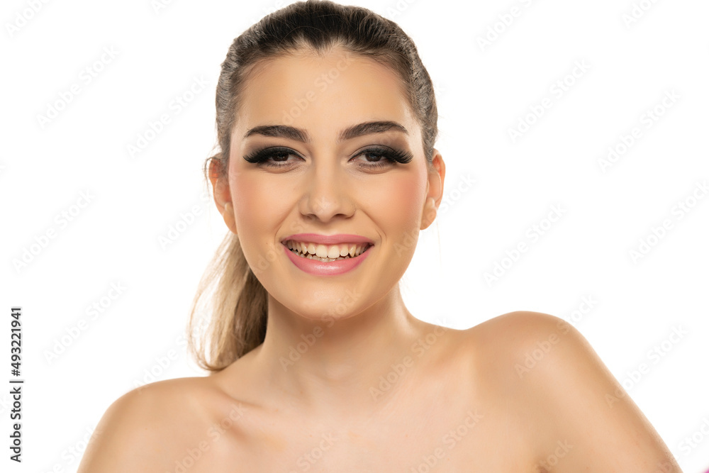Beautiful smiling brunette woman with beauty lashes and pink lipstick healthy skin isolated on white Beautiful smiling brunette woman with beauty lashes and pink lipstick healthy skin isolated on white