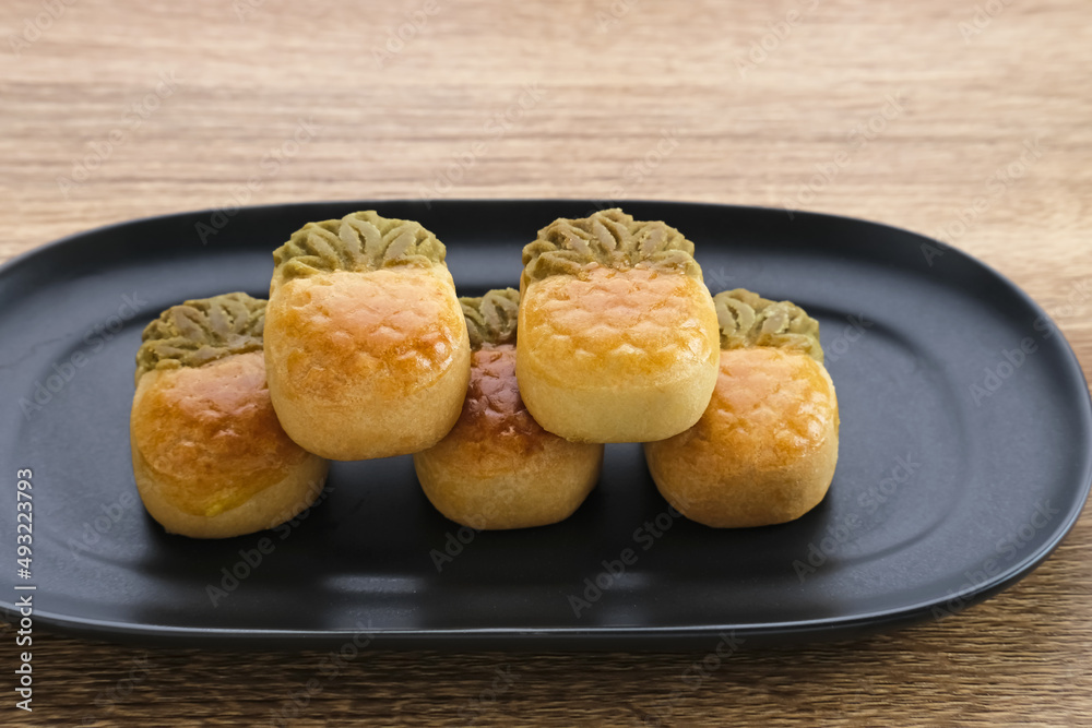 Nastar Cookies, Taiwanese Pineapple Cookies with pineapple-shaped filled with jam. Served on plate.