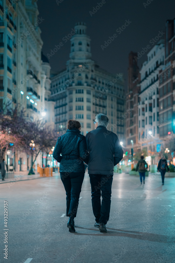 A couple walks through the city