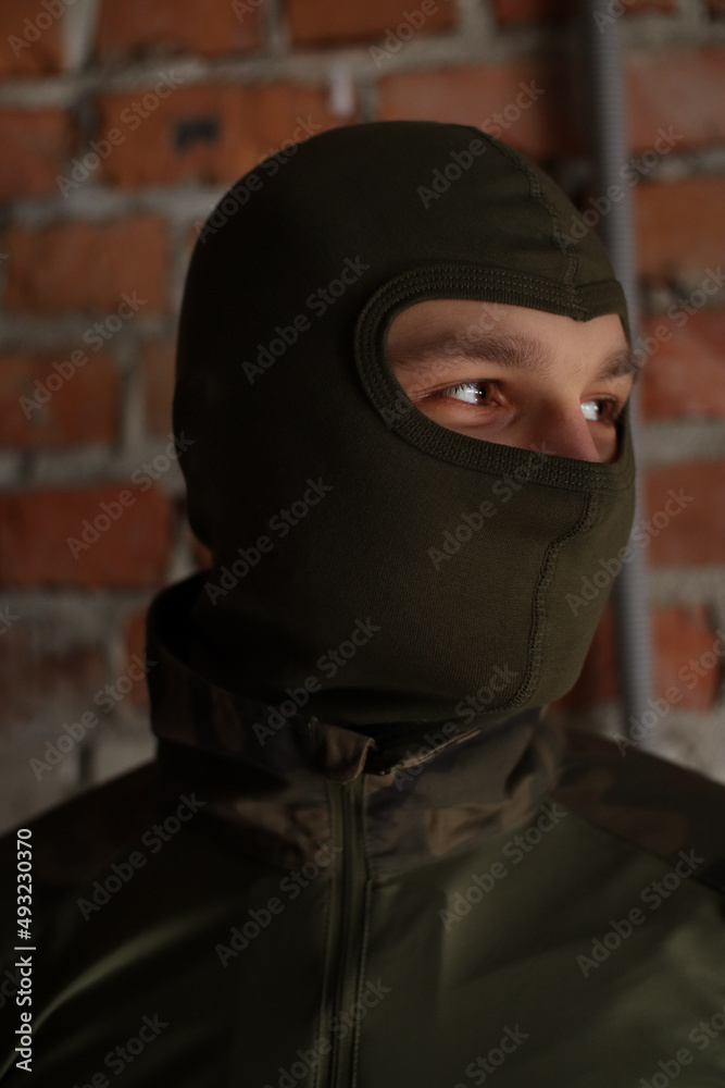 Soldier in a mask. The eyes of a man. Army. The military of Ukraine. Ammunition and tactical clothing Soldier in a mask. The eyes of a man. Army. The military of Ukraine. Ammunition and tactical clothing