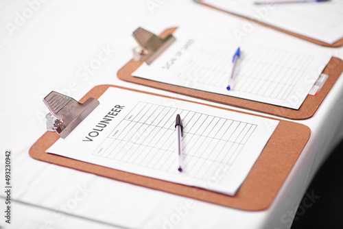 Give a little back. Shot of a volunteer lists on a table.