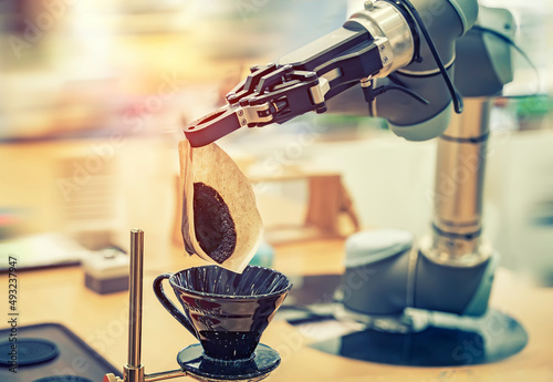 automatic robot arm preparing coffee with coffee machine