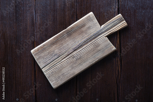 Empty cutting board on wooden brown background. copy space for text