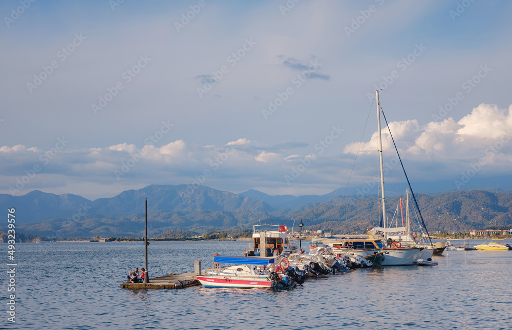 Fethiye Harbour, Turkey promenade of the city of Fethiye, boats are at bay in the blue waters of the Mediterranean. The resort town of Turkey.