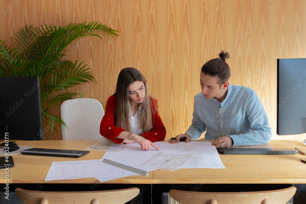 Architects, man and woman, working together on a project Architects, man and woman, working together on a project
