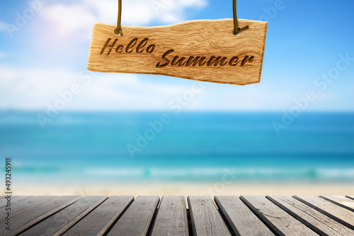 Fototapeta Naklejka Na Ścianę i Meble -  Summer vacation concept sea beach blurry background. Hello summer wooden sign
