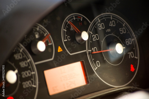 Speedometer close up over a black background.