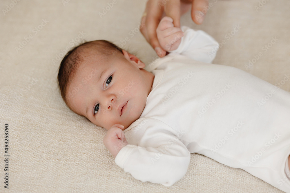 Newborn holding his father's finger