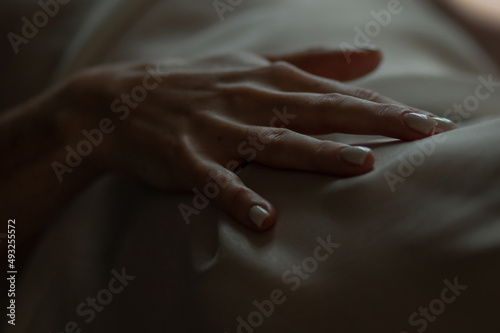 Close-up of a woman's hand. Gentle and sensual movement. Female attractiveness and temptation. Soft focus and beautiful bokeh.