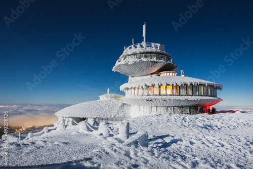 Winter view of the Meteorological Observatory on Śnieżka in the Karkonosze Mountains. The night landscape looks like it's on another planet.