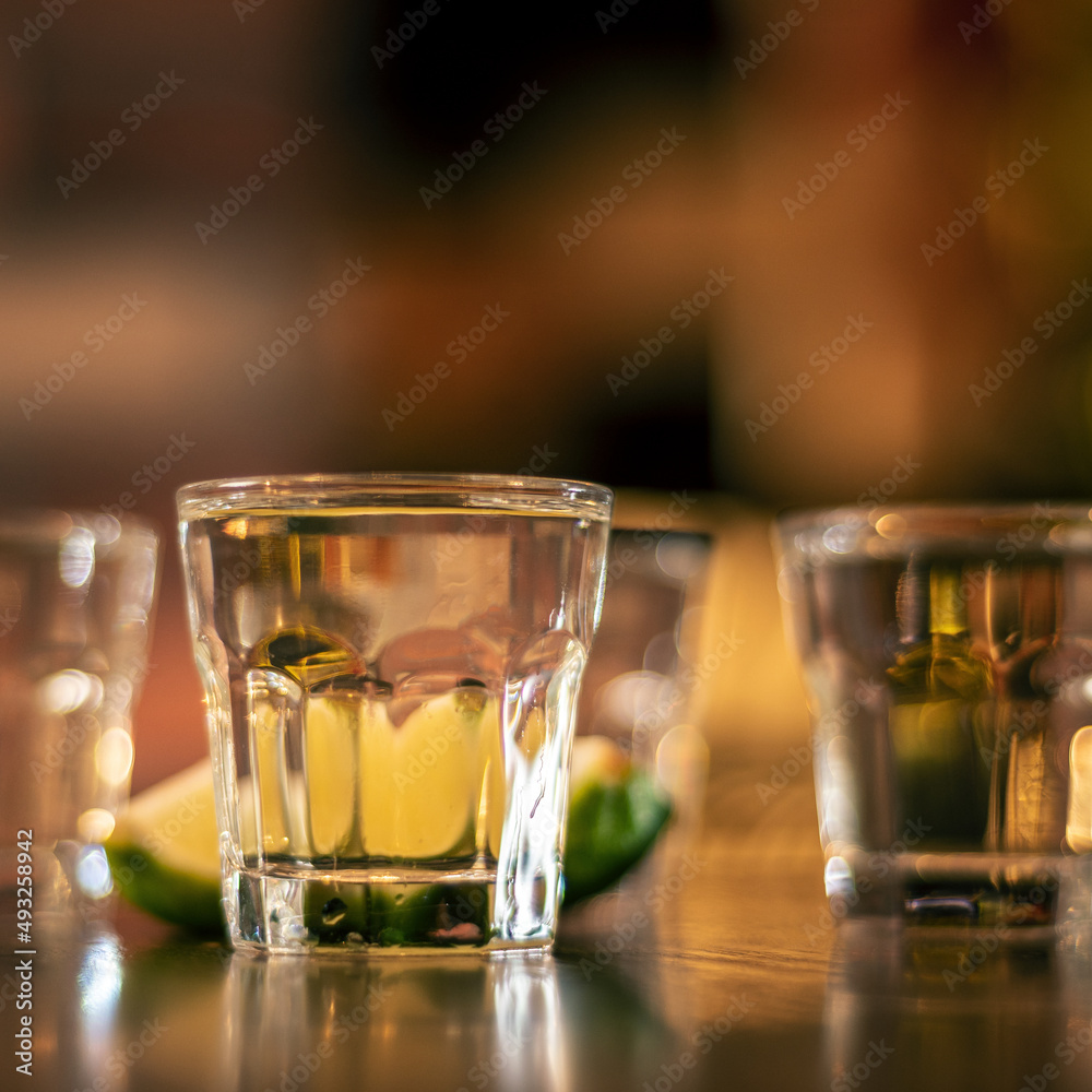 vodka shots on wooden table closeup square vodka shots on wooden table closeup square