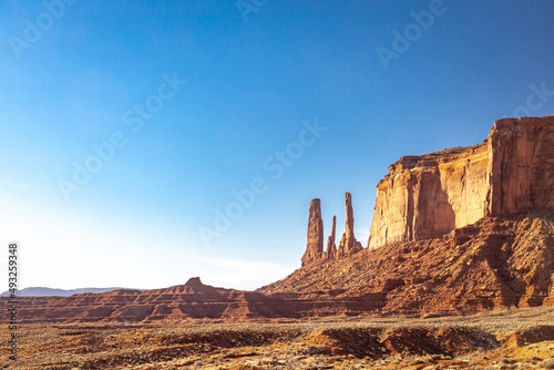 Classic southwest desert landscape under a blue sky and bright sun in Monument Valley in Arizona and Utah.