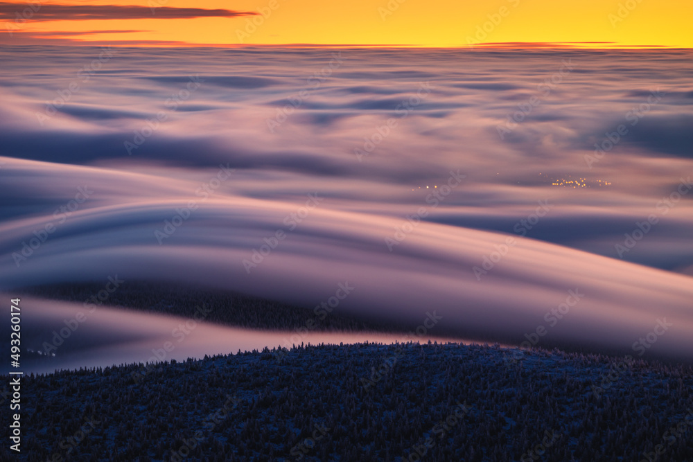 Winter morning on Śnieżka in the Karkonosze Mountains, colorful dawn heralds a beautiful day.