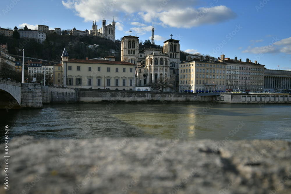 Magnificent view of the Basilica of Notre Dame de Fouvière with in the foreground the Cathedral Saint Jean Baptiste, the Bonaparte Bridge on its left and in the Saone River in Lyon, france