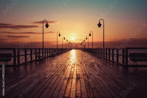 Beautiful morning seaside landscape. Wooden pier with a colorful sky in Gdynia Orlowo  Poland.