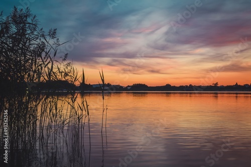 Beautiful colorful morning landscape. Wonderful sky over a Polish lake.