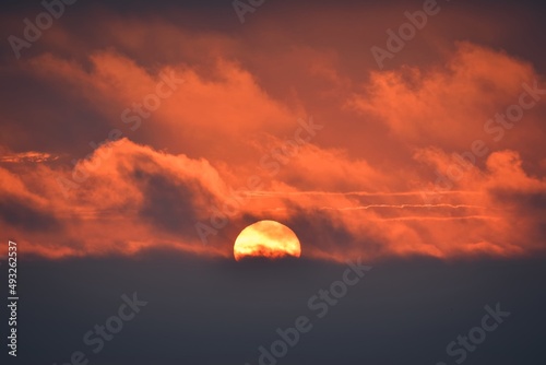 Beautiful colorful abstract piece of heaven. Yellow sun on a background of clouds at sunset.