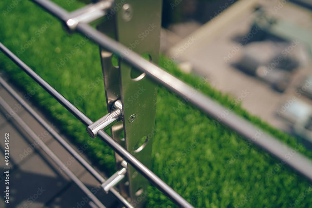 Metal fences on high-rise buildings, beautiful grass, blurred background