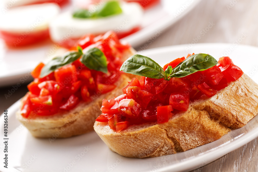 Italian appetizer bruschetta with fresh tomatoes on a plate Italian appetizer bruschetta with fresh tomatoes on a plate
