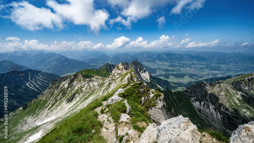 Panoramic view from Nebelhorn in Oberstdorf Allgäu Bavaria Germany - Beautiful Alps with lush green meadow and blue sky - Mountains landscape background banner panorama photo