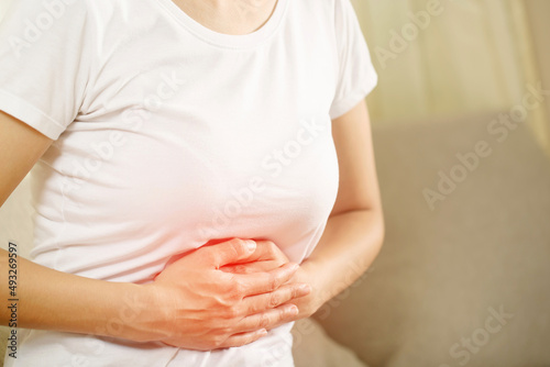 Woman having a stomachache, or menstruation pain. suffering from abdominal. Menstrual cramps. Healthcare and medical, gynecology concept. © methaphum
