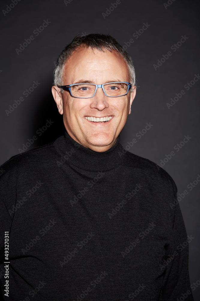 Happiness in the studio. Studio portrait of a mature man isolated on black.