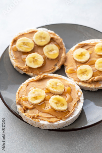 Peanut butter over rice cakes and honey. Healthy protein snack for breakfast