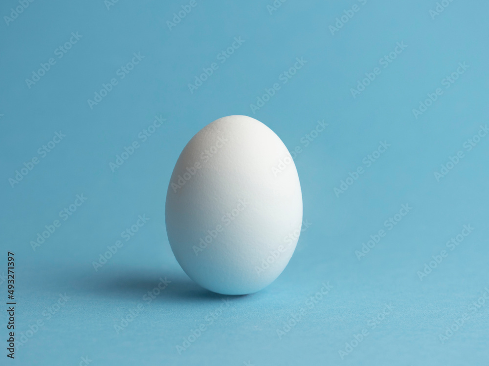 Egg on a blue background. Minimalism. Easter holiday. Egg on a blue background. Minimalism. Easter holiday.
