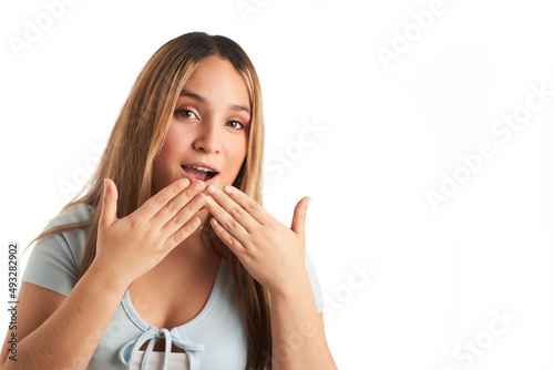 Young woman with surprised gesture with hands on mouth. isolated on white background