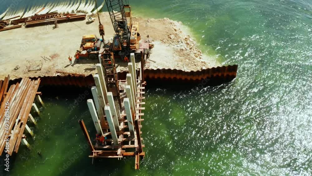 Pile driver hammer in action. Construction bridge over the sea bay on the tropical island of Siargao. Pile driver hammer in action. Construction bridge over the sea bay on the tropical island of Siargao.