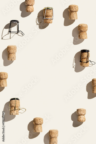 Frame with champagne cork on beige background with shadow at sunlight. Summer wine drinks concept, trend layout with bottle cap from sparkling wine and metal wire muselet, copy space