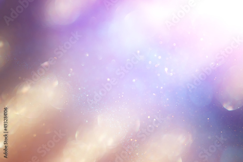 abstract background of glitter vintage lights. silver, purple and gold. de-focused