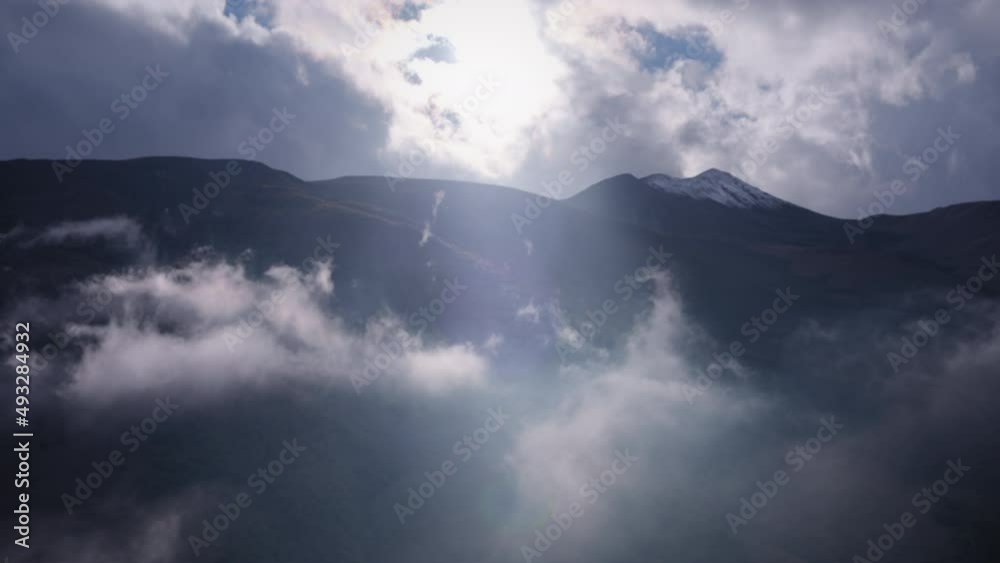 Sunlight shining through clouds that moving fast along the mountain hills. Timelapse. Sunlight shining through clouds that moving fast along the mountain hills. Timelapse.